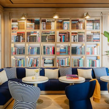 a room with a couch and bookshelf