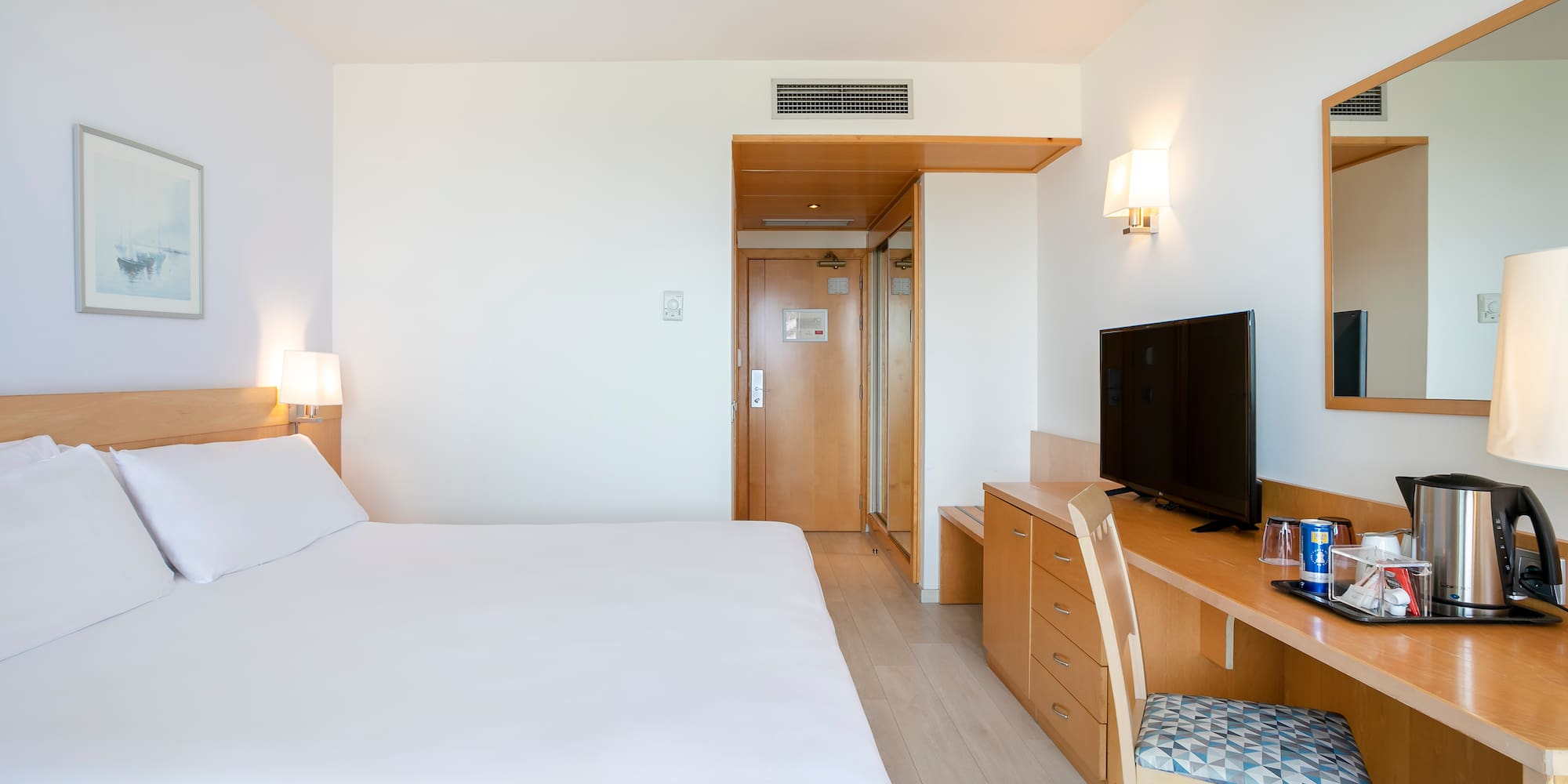 a bedroom with a bed and a desk