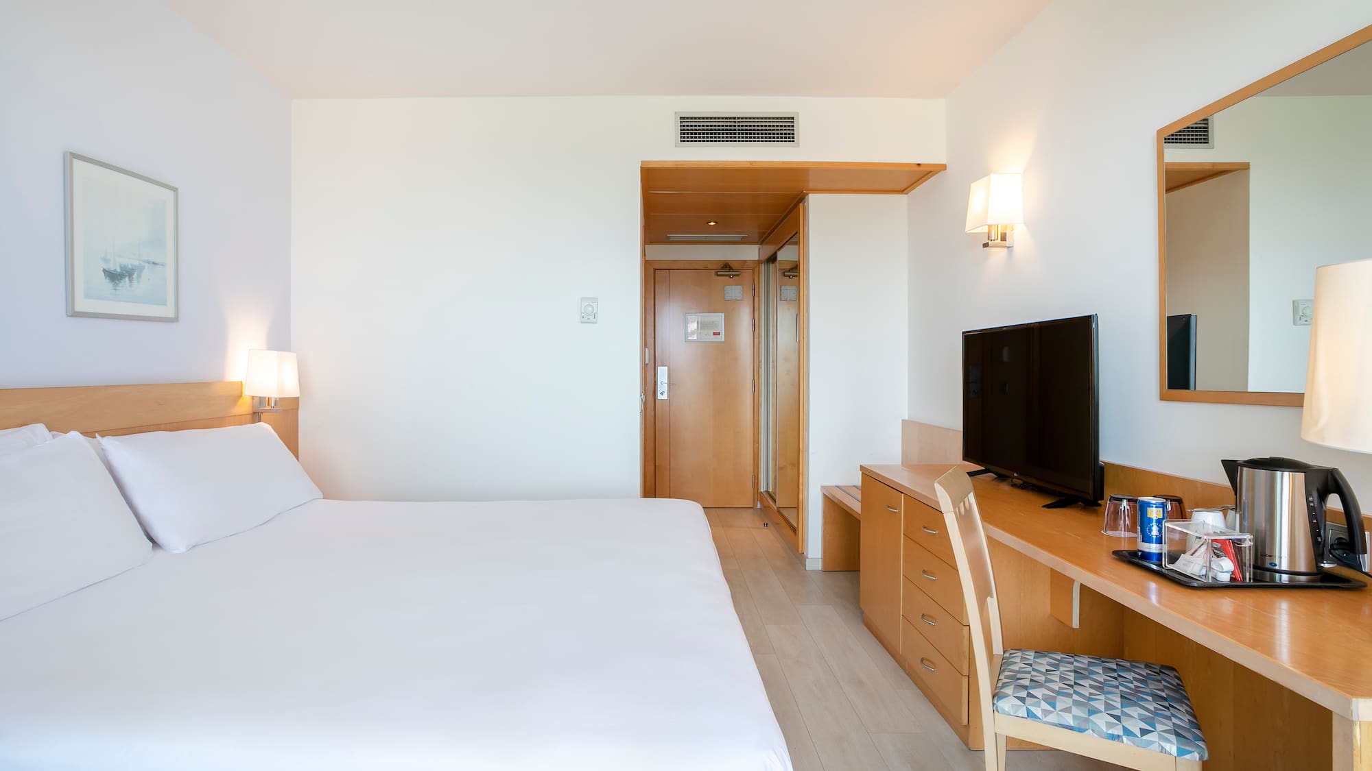 a bedroom with a bed and a desk