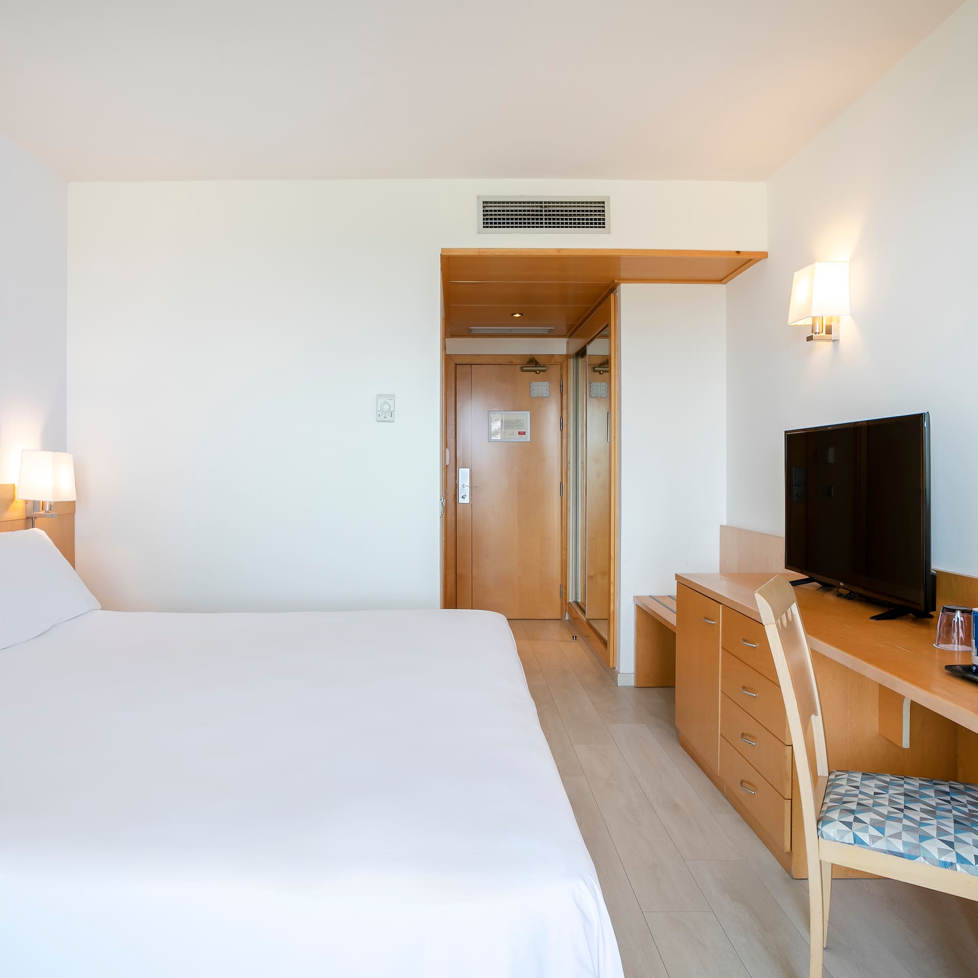 a bedroom with a bed and a desk