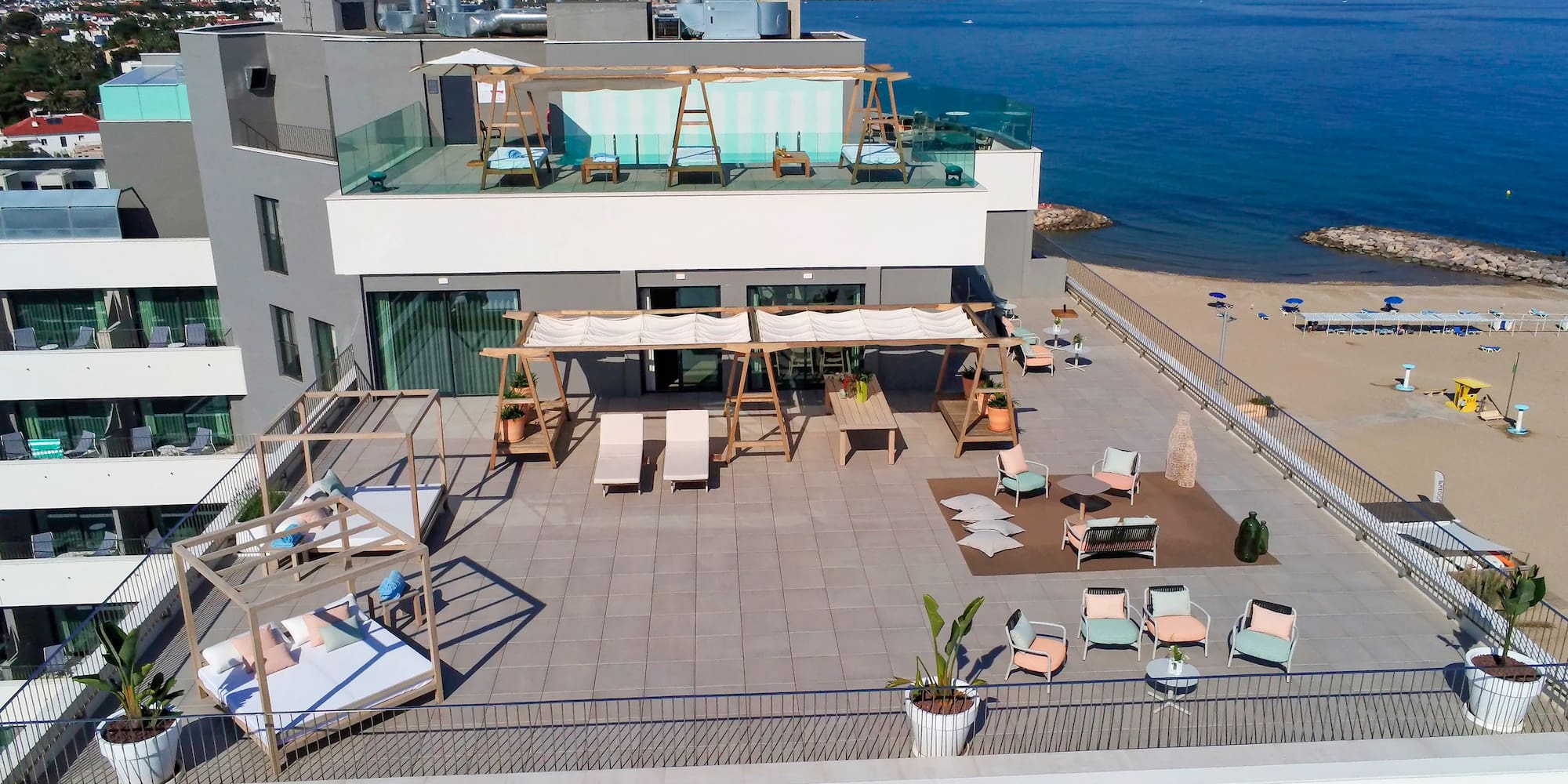 a rooftop of a building with a beach and water in the background