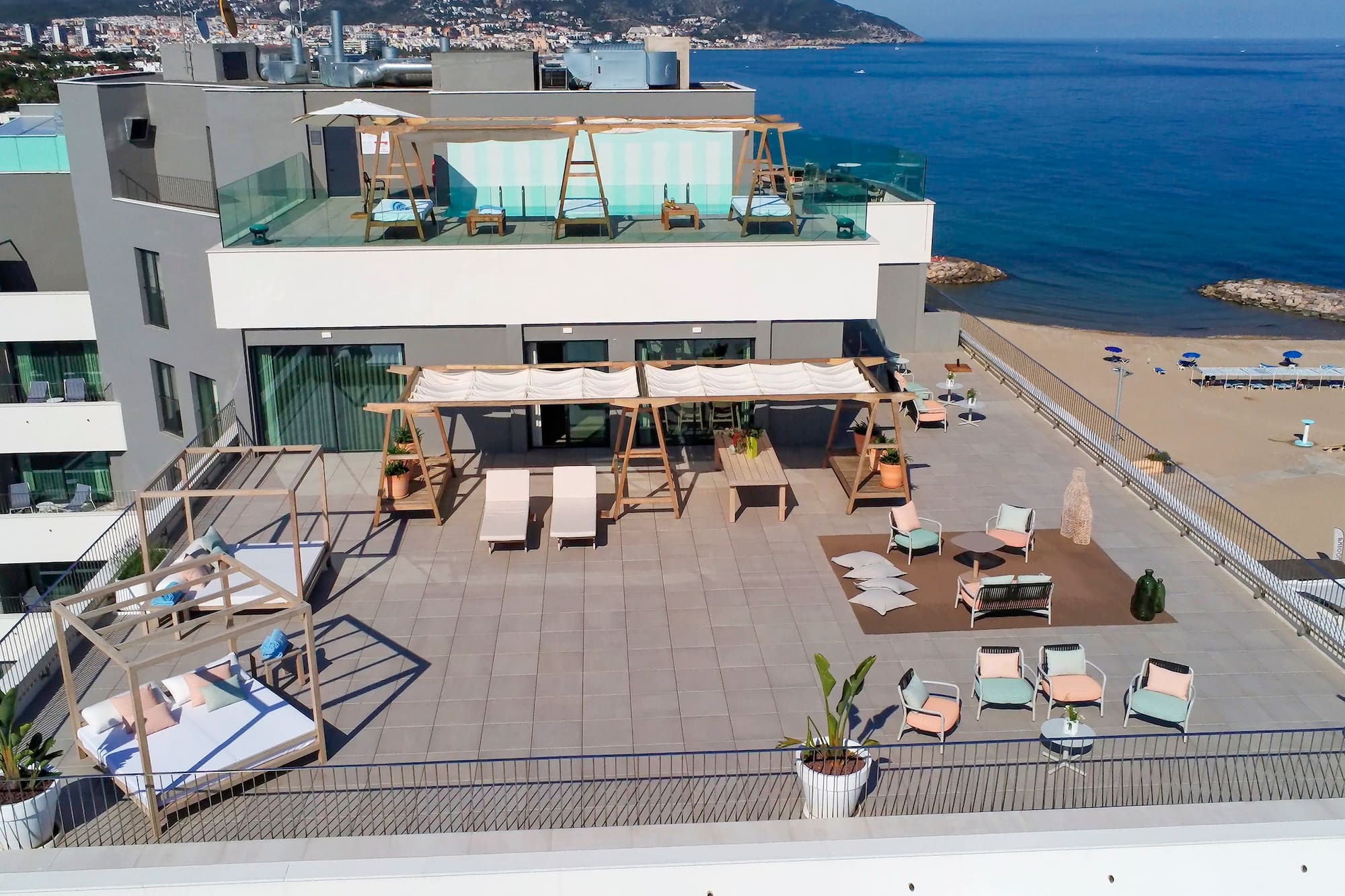 a rooftop of a building with a beach and water in the background