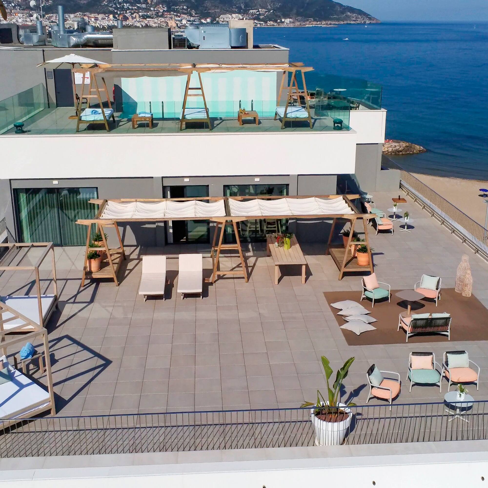 a rooftop of a building with a beach and water in the background