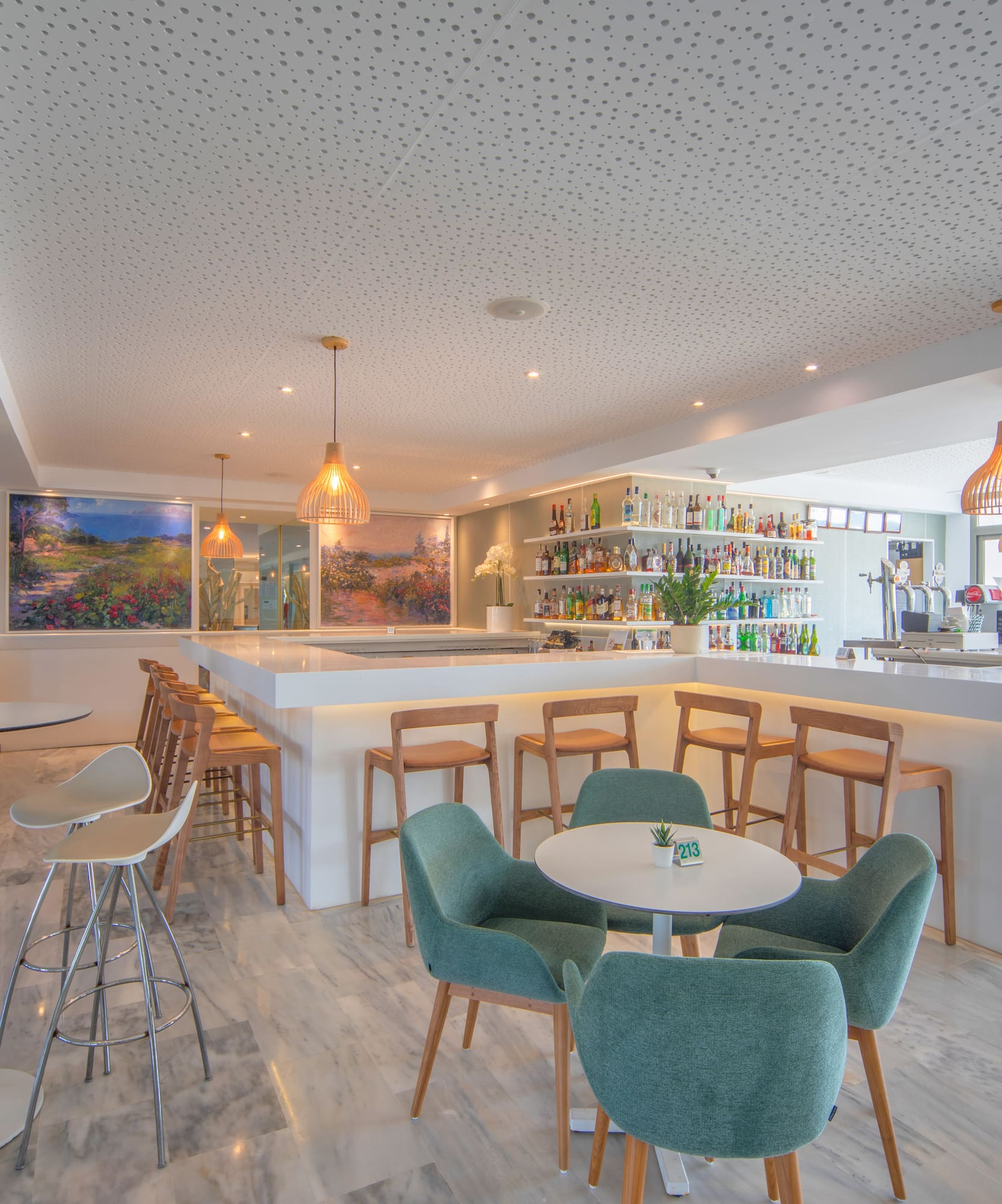 a room with a bar and tables and chairs