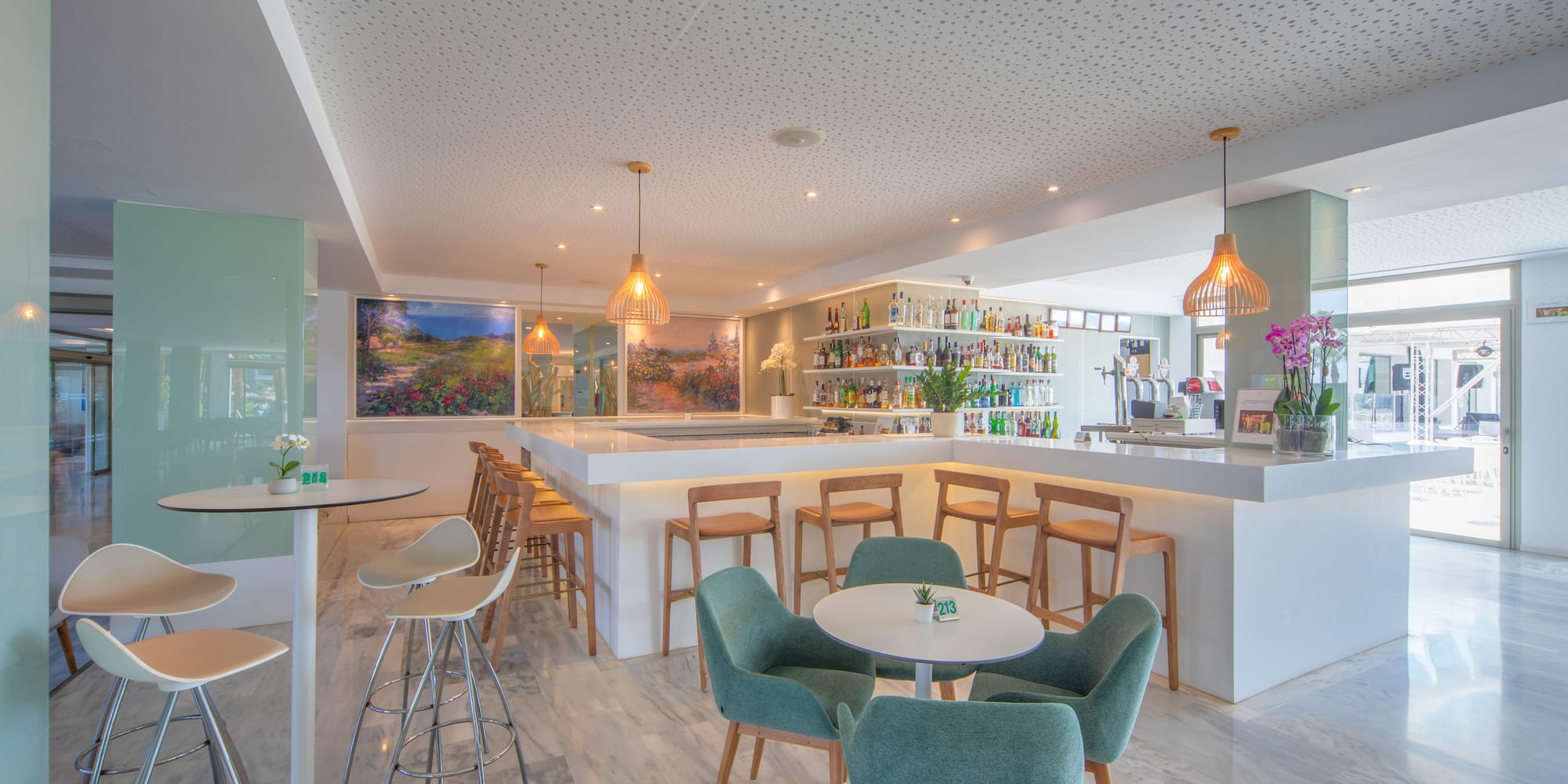 a room with a bar and tables and chairs