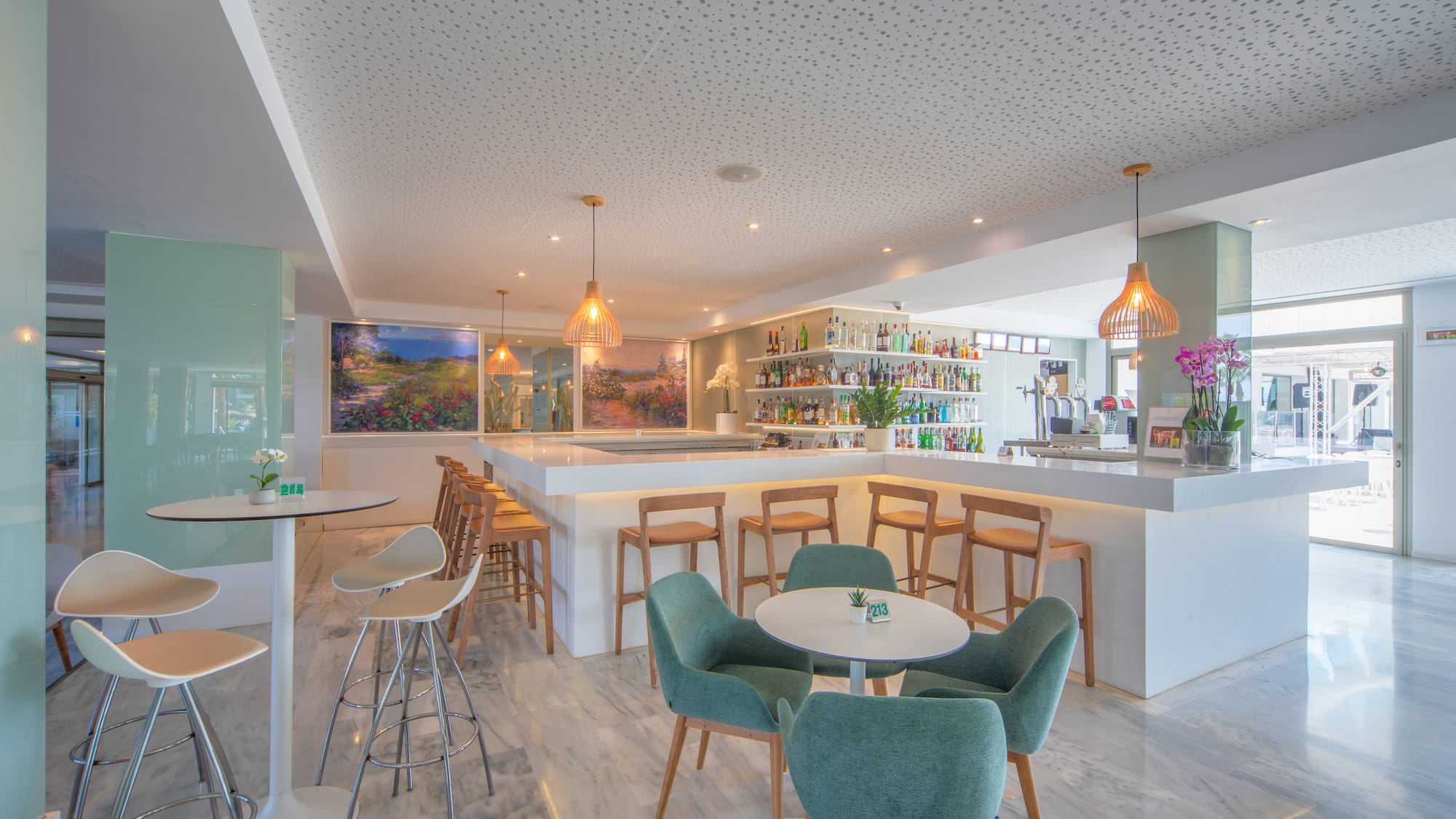 a room with a bar and tables and chairs