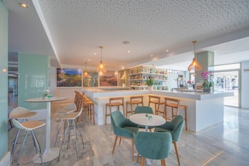 a room with a bar and tables and chairs