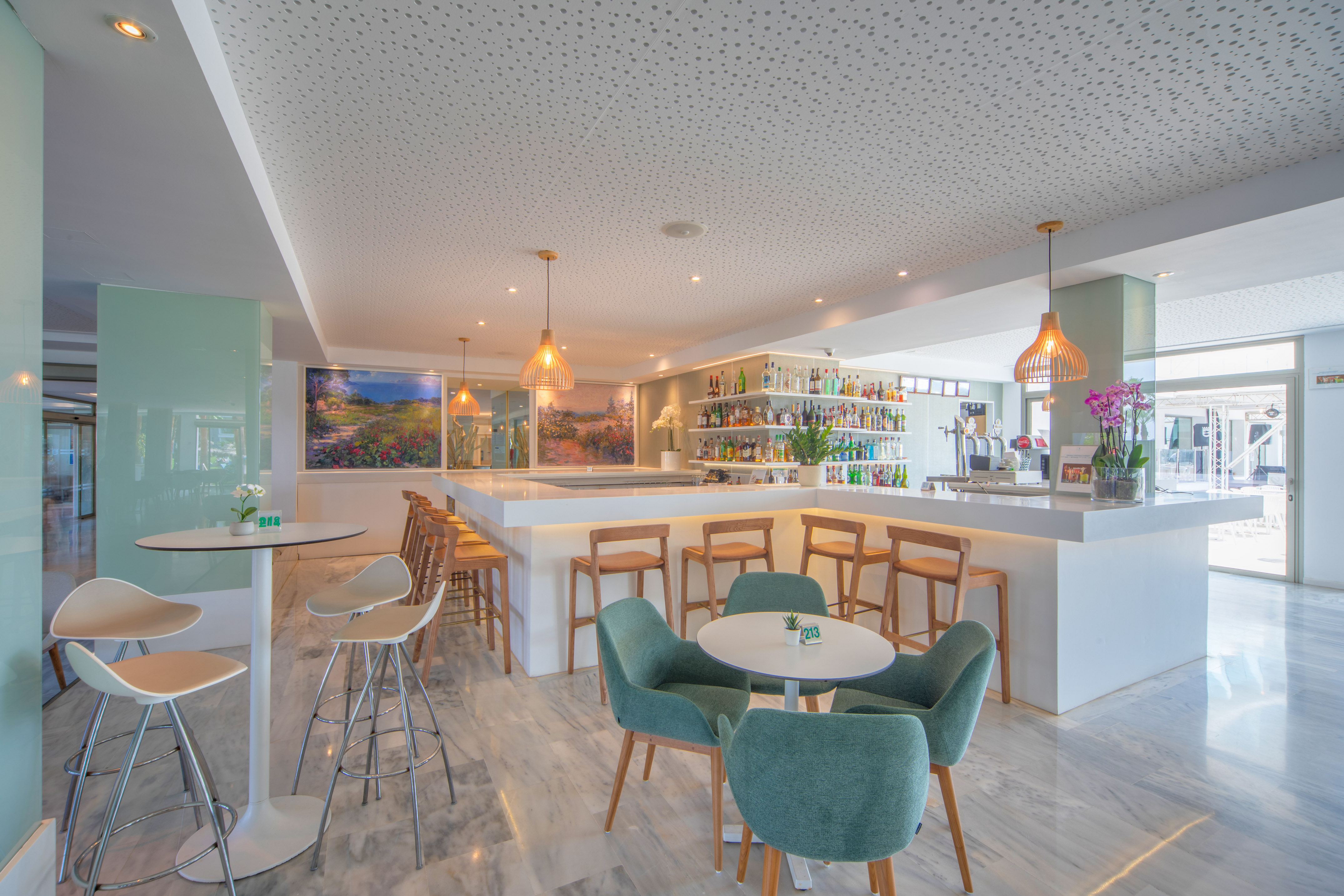 a room with a bar and tables and chairs