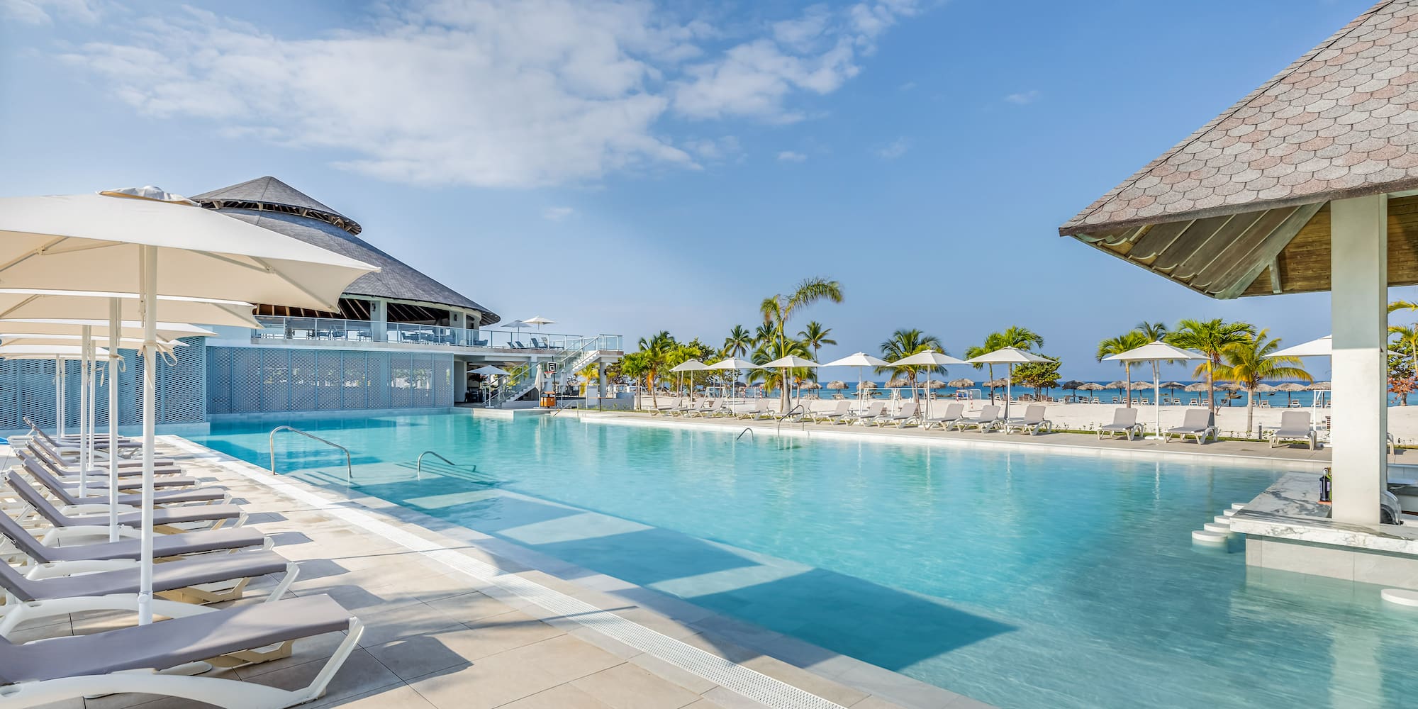 a pool with umbrellas and chairs