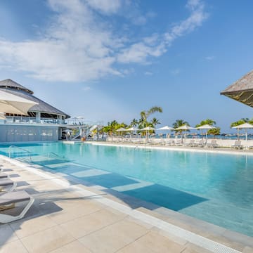 a pool with umbrellas and chairs