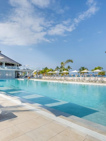 a pool with umbrellas and chairs