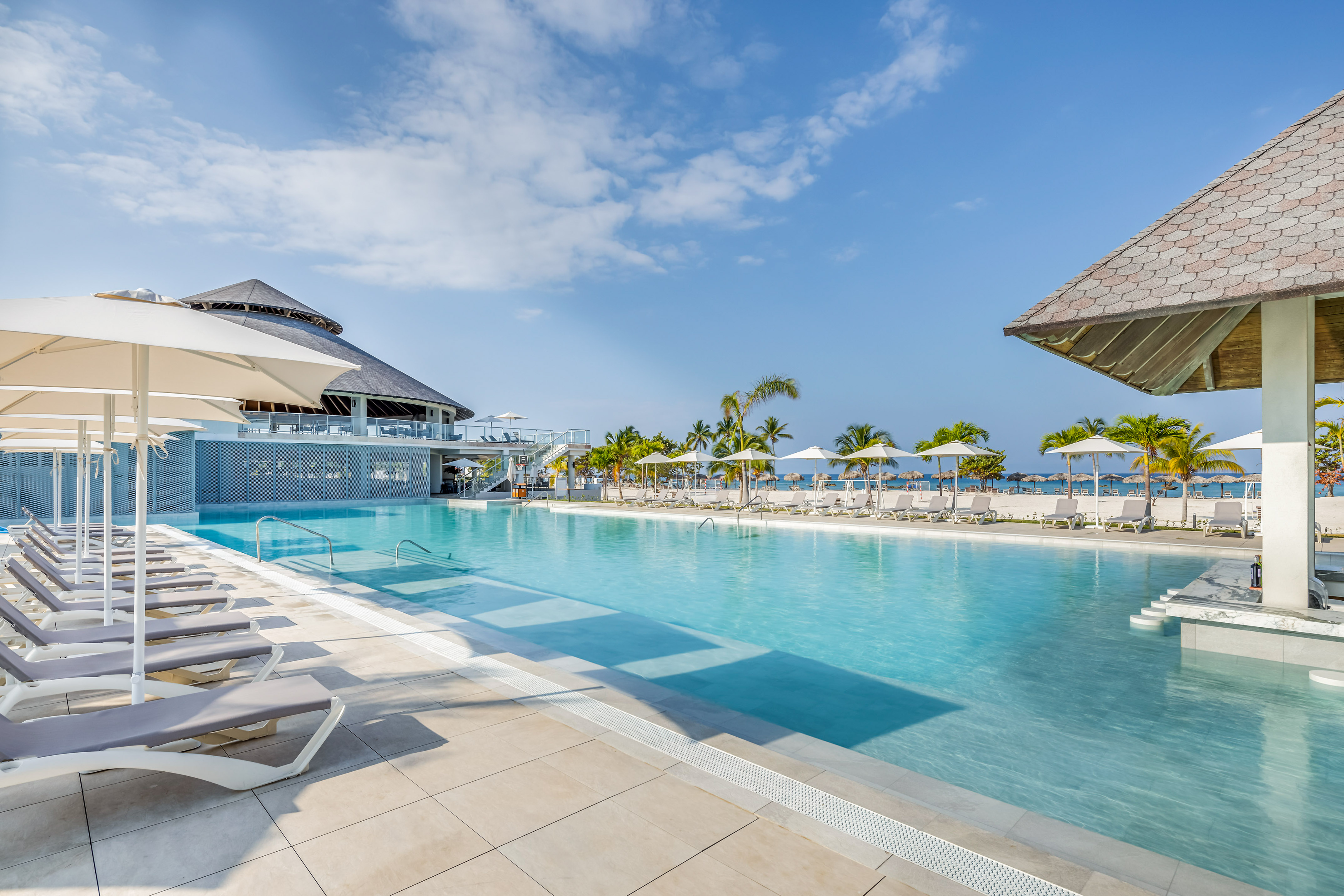 a pool with umbrellas and chairs