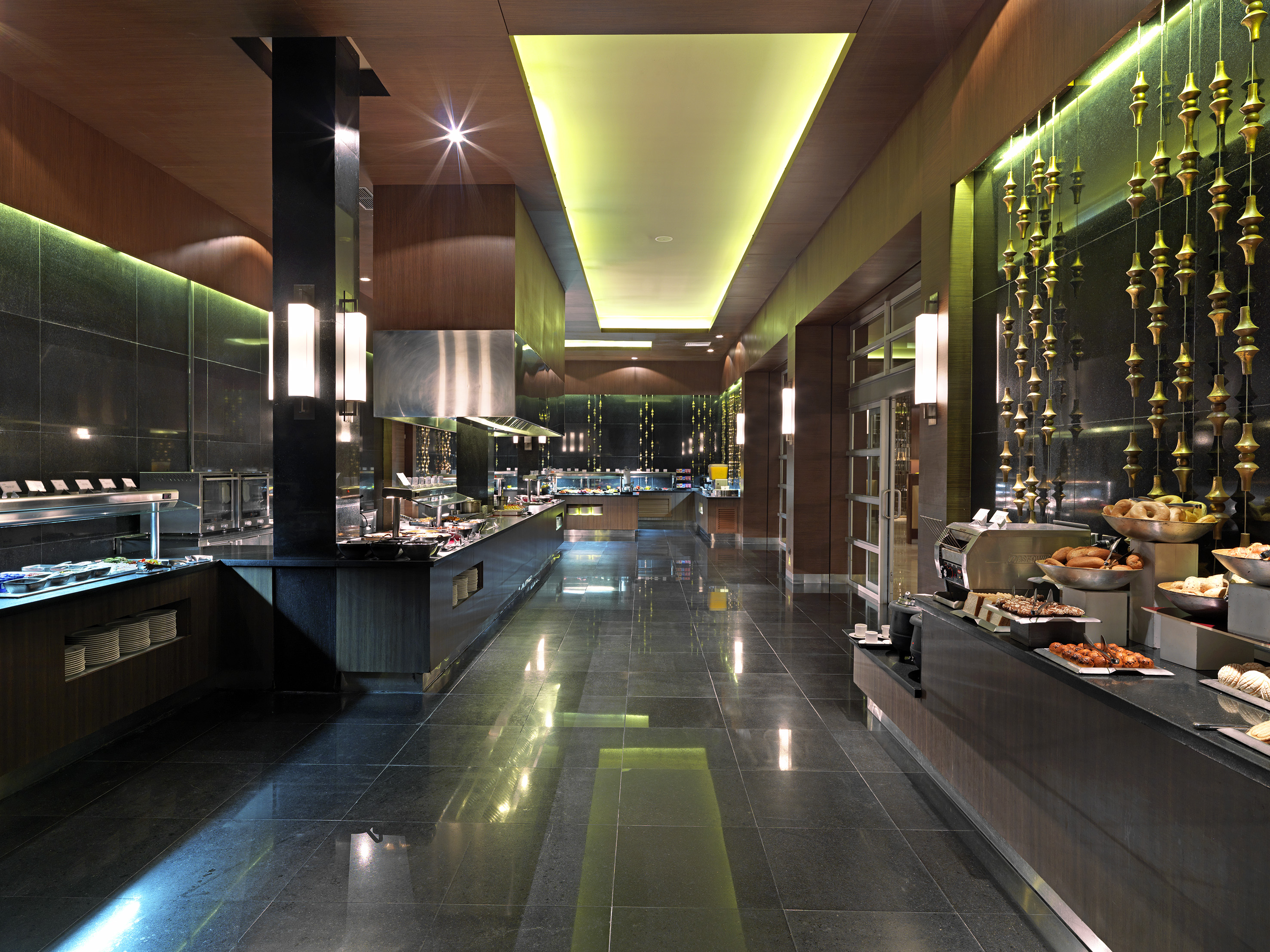 Modern hotel buffet interior with elegant food display and ambient lighting.