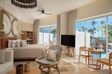 a room with a bed and a television