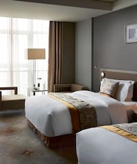 a room with two beds and a lamp