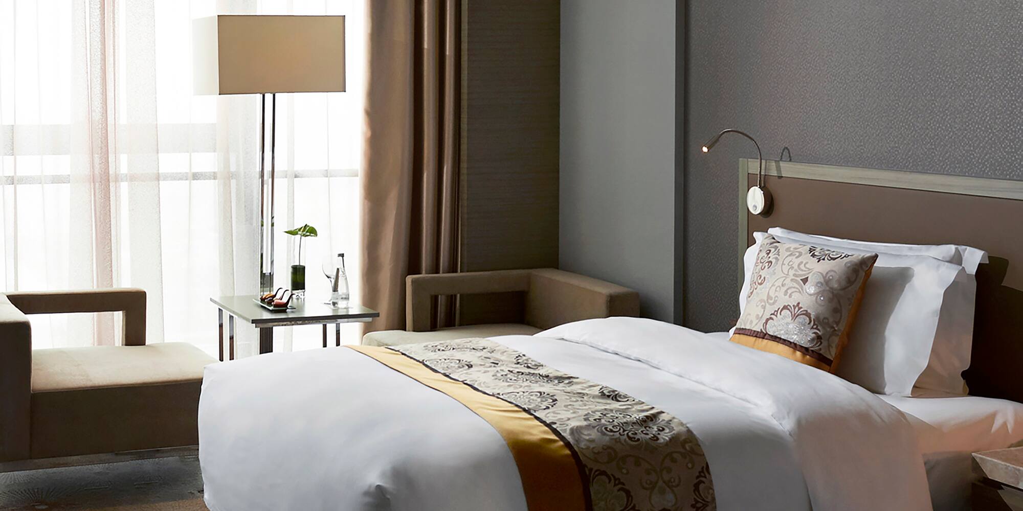 a room with two beds and a lamp