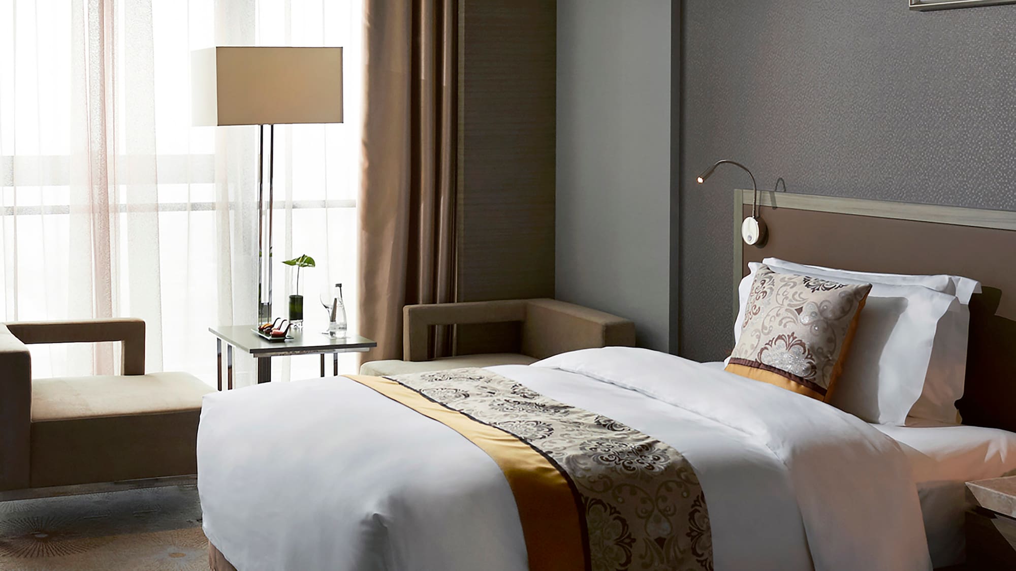 a room with two beds and a lamp