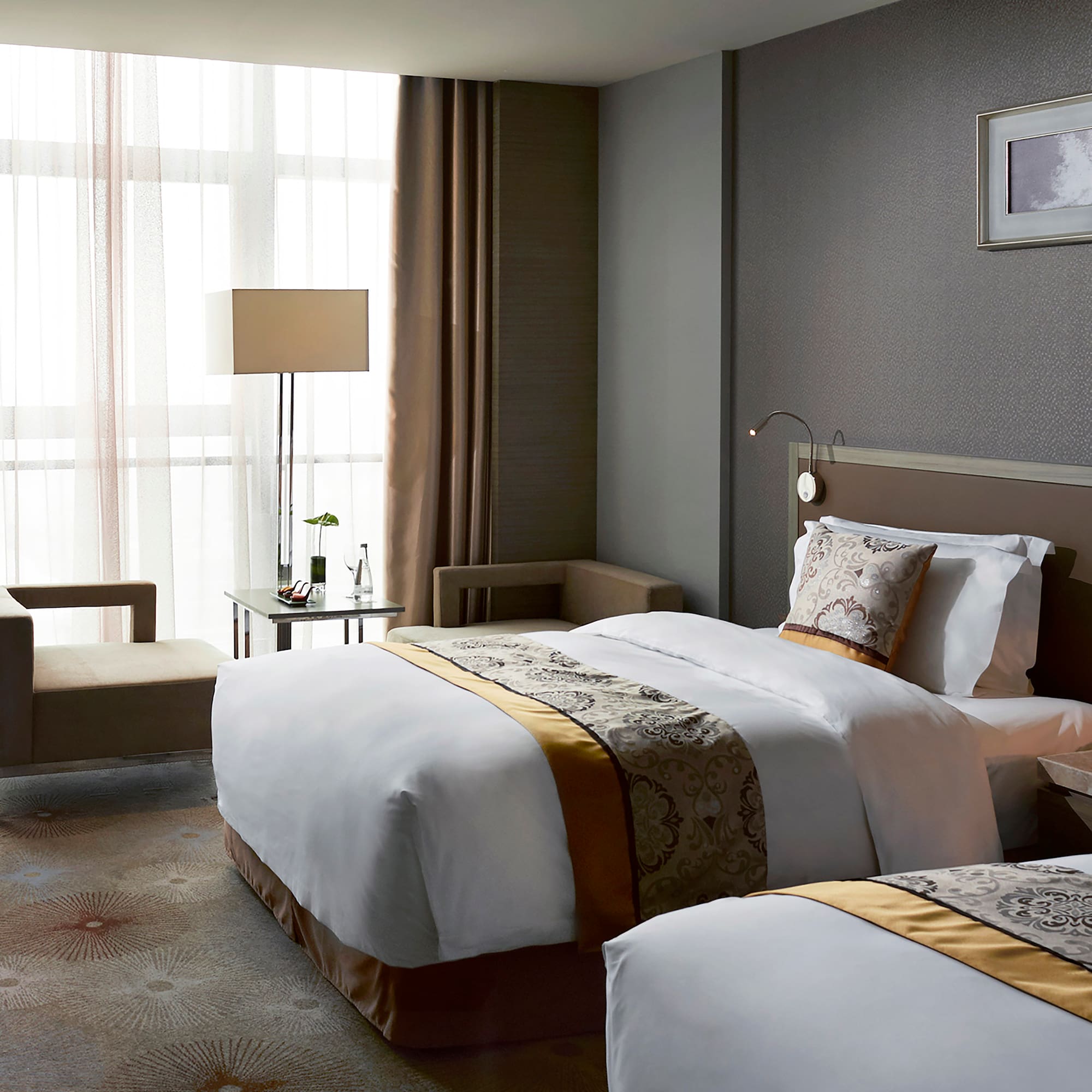 a room with two beds and a lamp