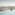 a woman in a swimsuit in a pool overlooking a city