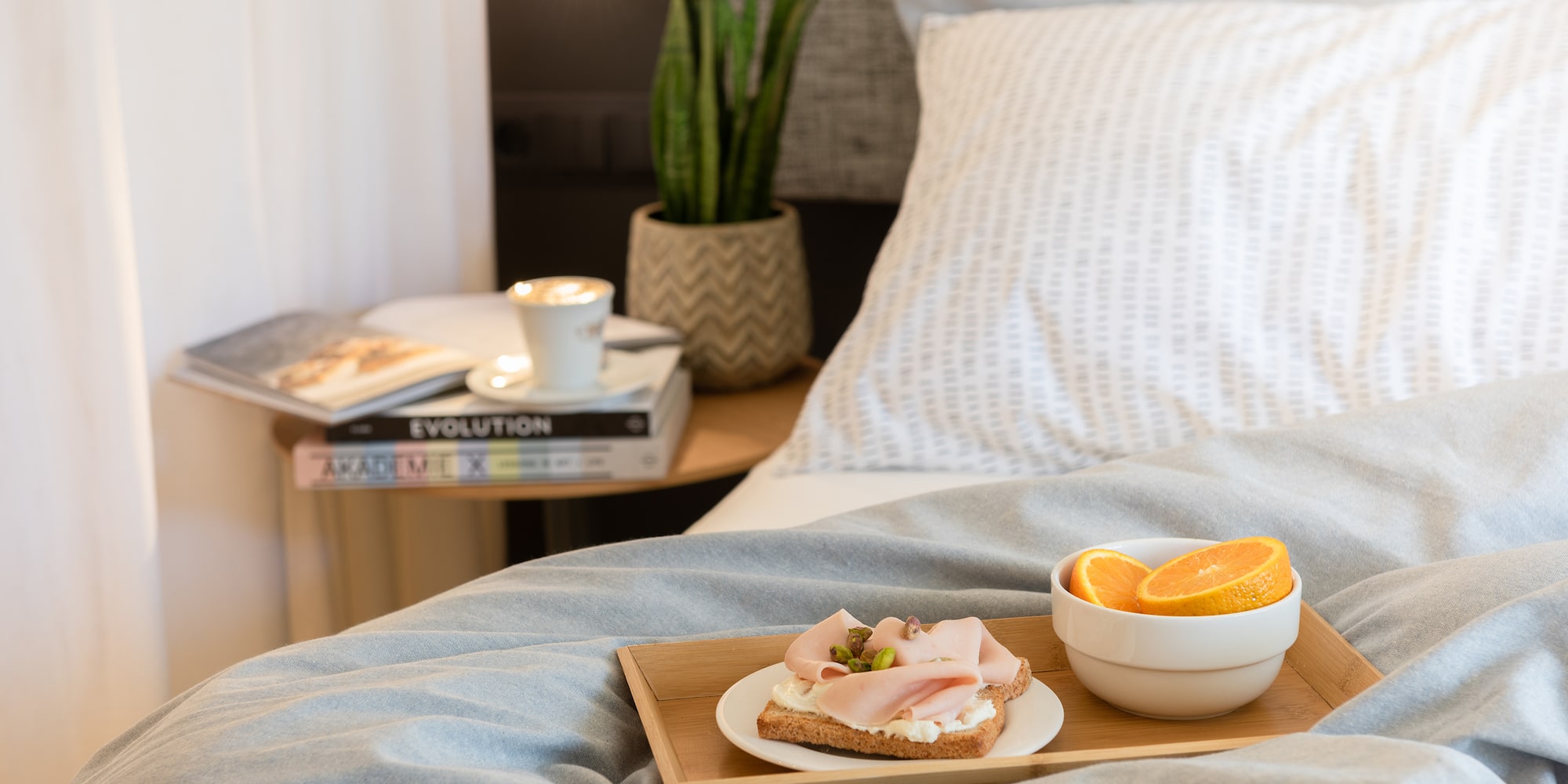 a plate of food on a tray in a bed