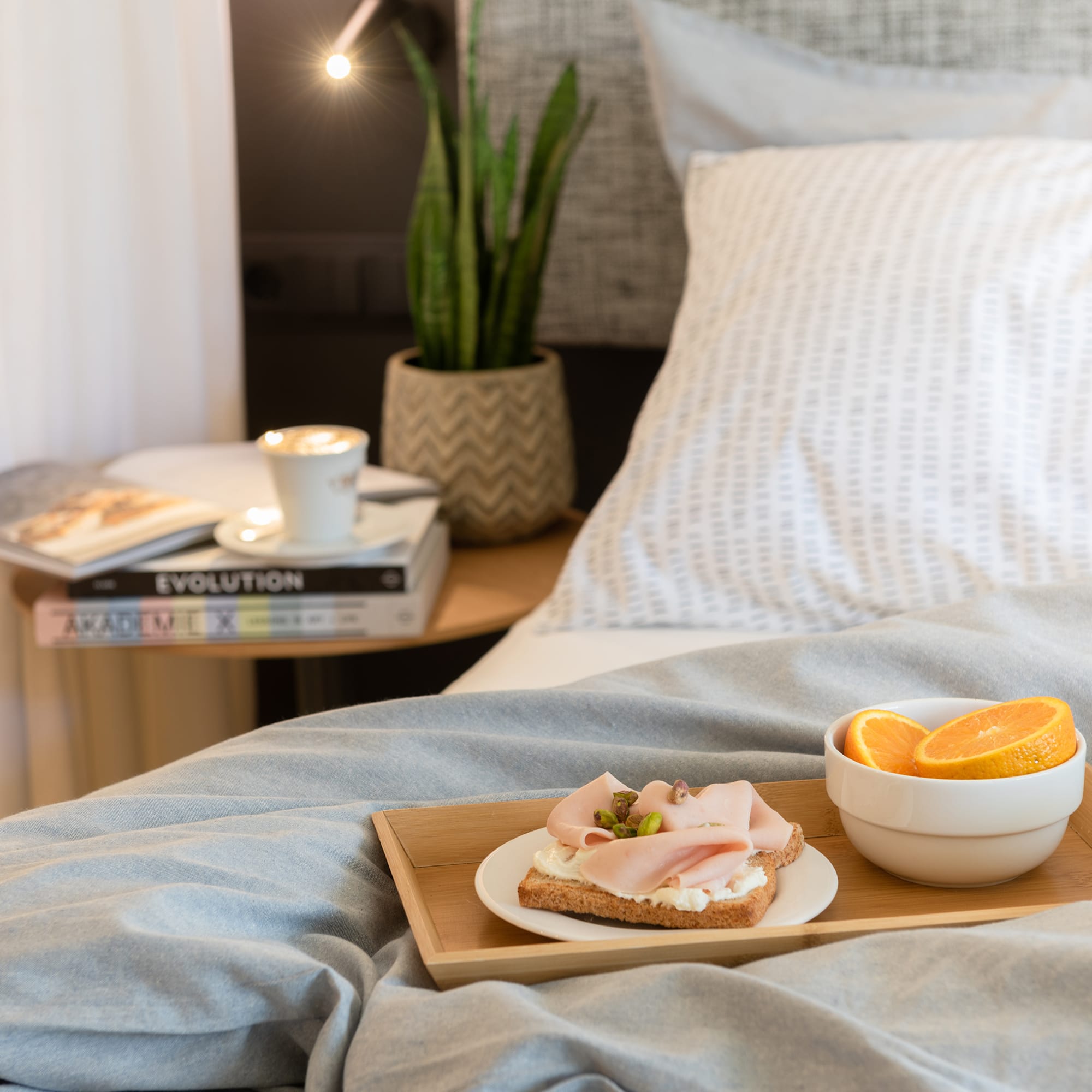 a plate of food on a tray in a bed