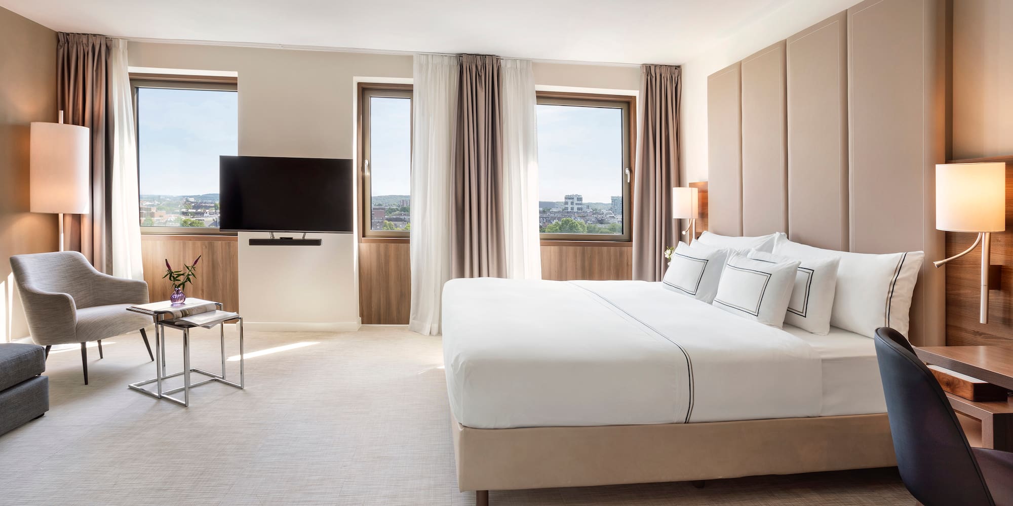 a bedroom with a large bed and a television