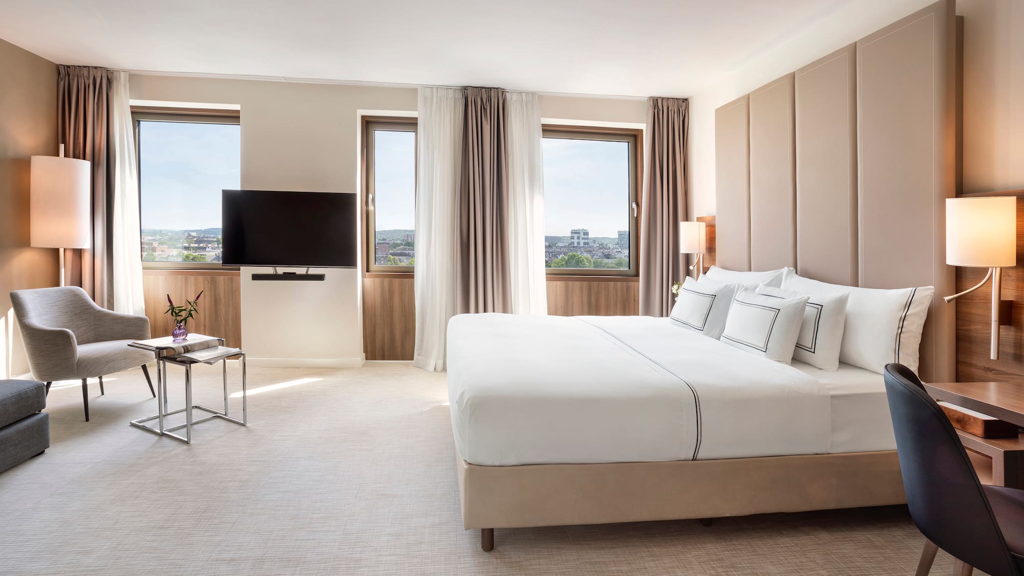 a bedroom with a large bed and a television