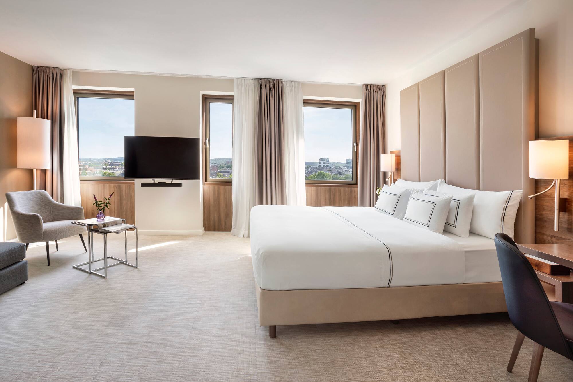 a bedroom with a large bed and a television