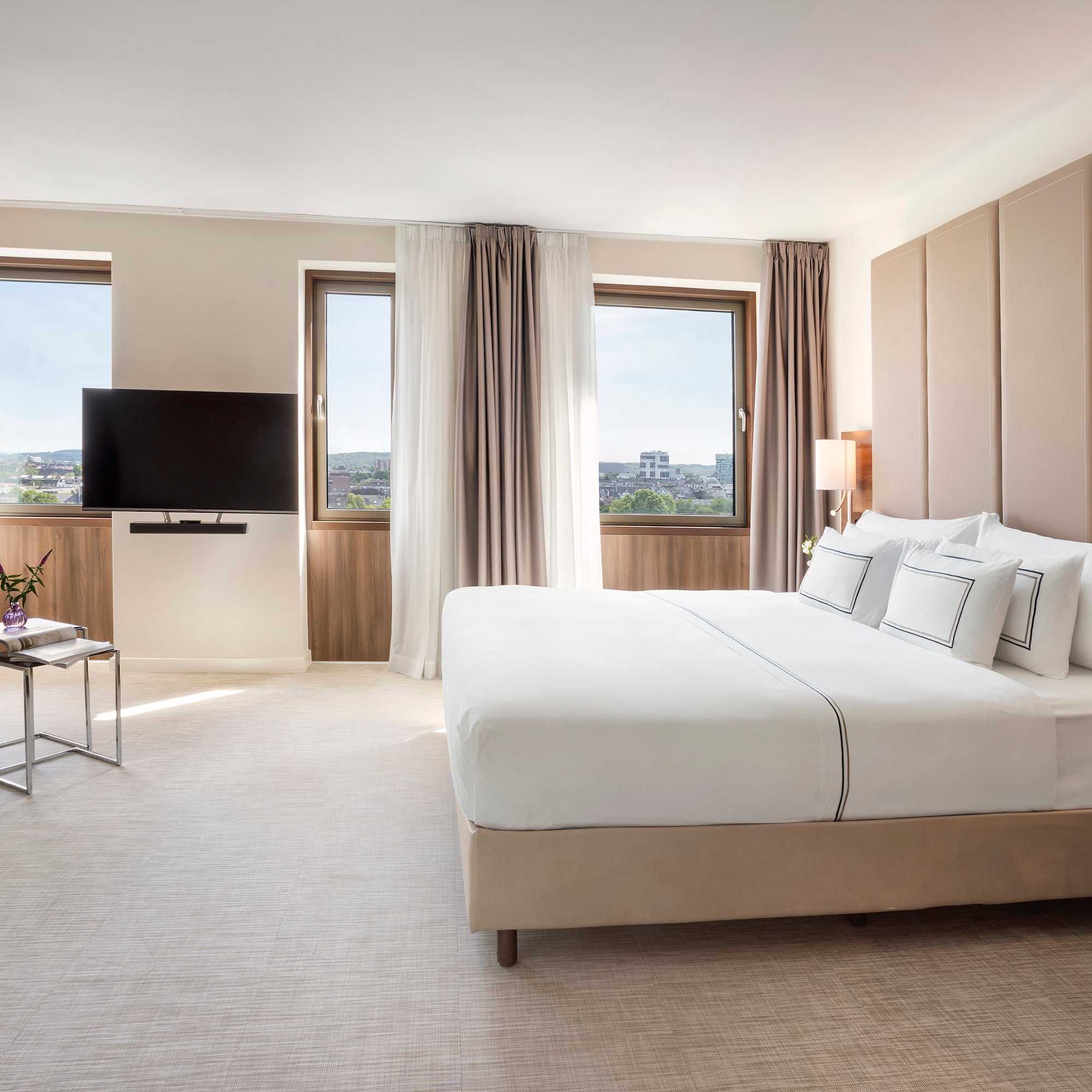 a bedroom with a large bed and a television