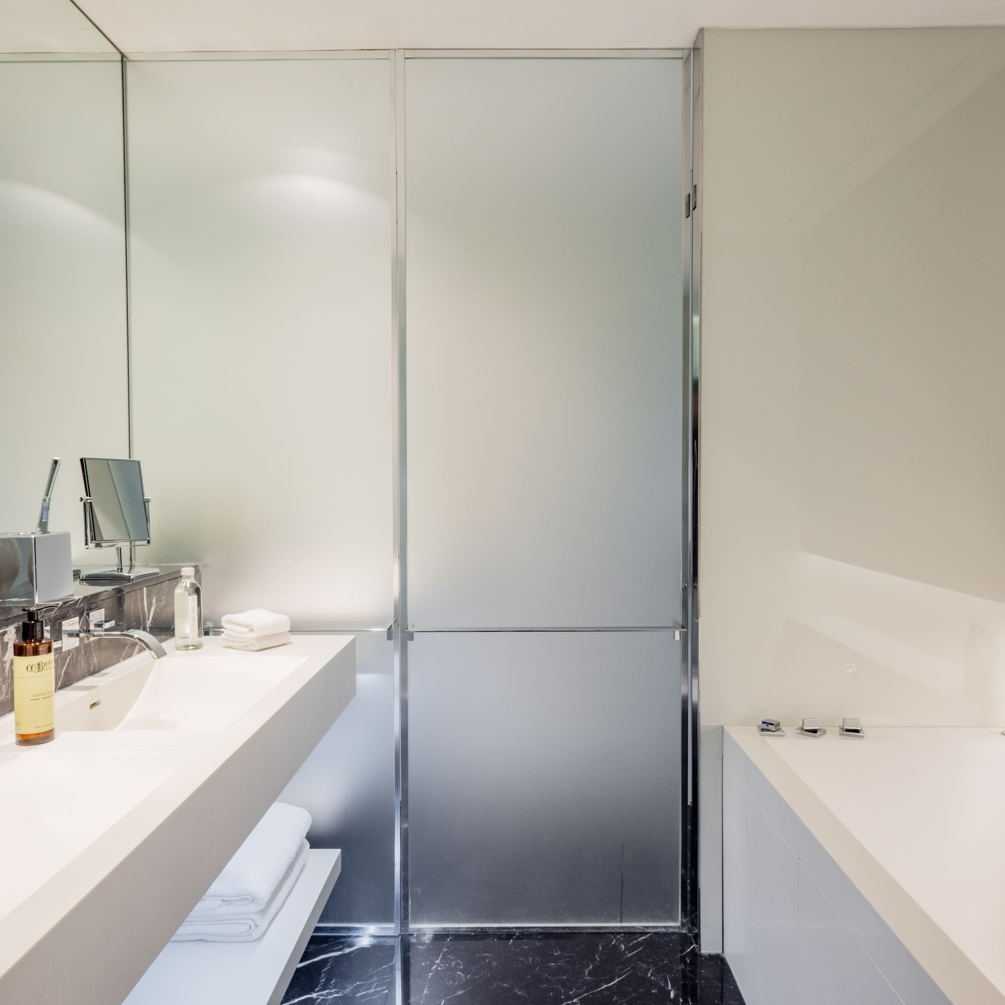 a bathroom with a glass shower door