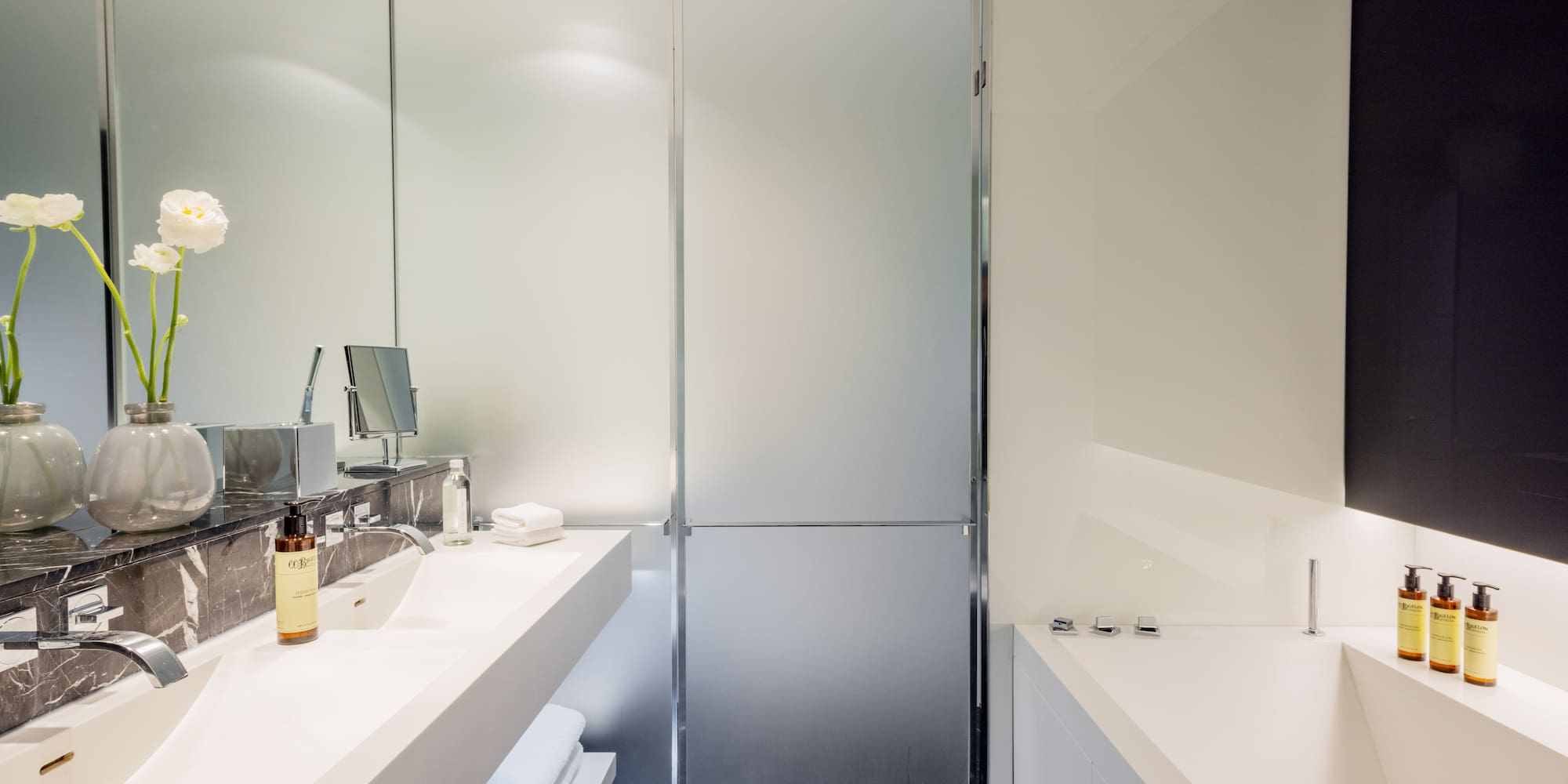 a bathroom with a glass shower door