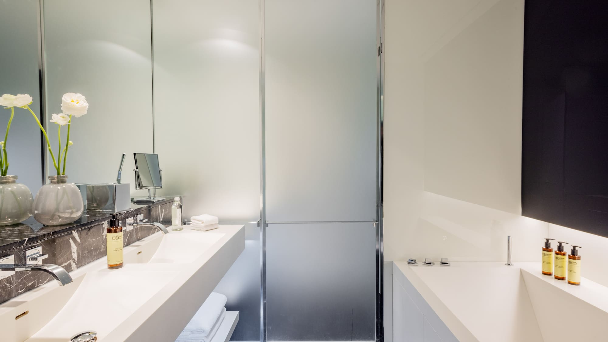 a bathroom with a glass shower door