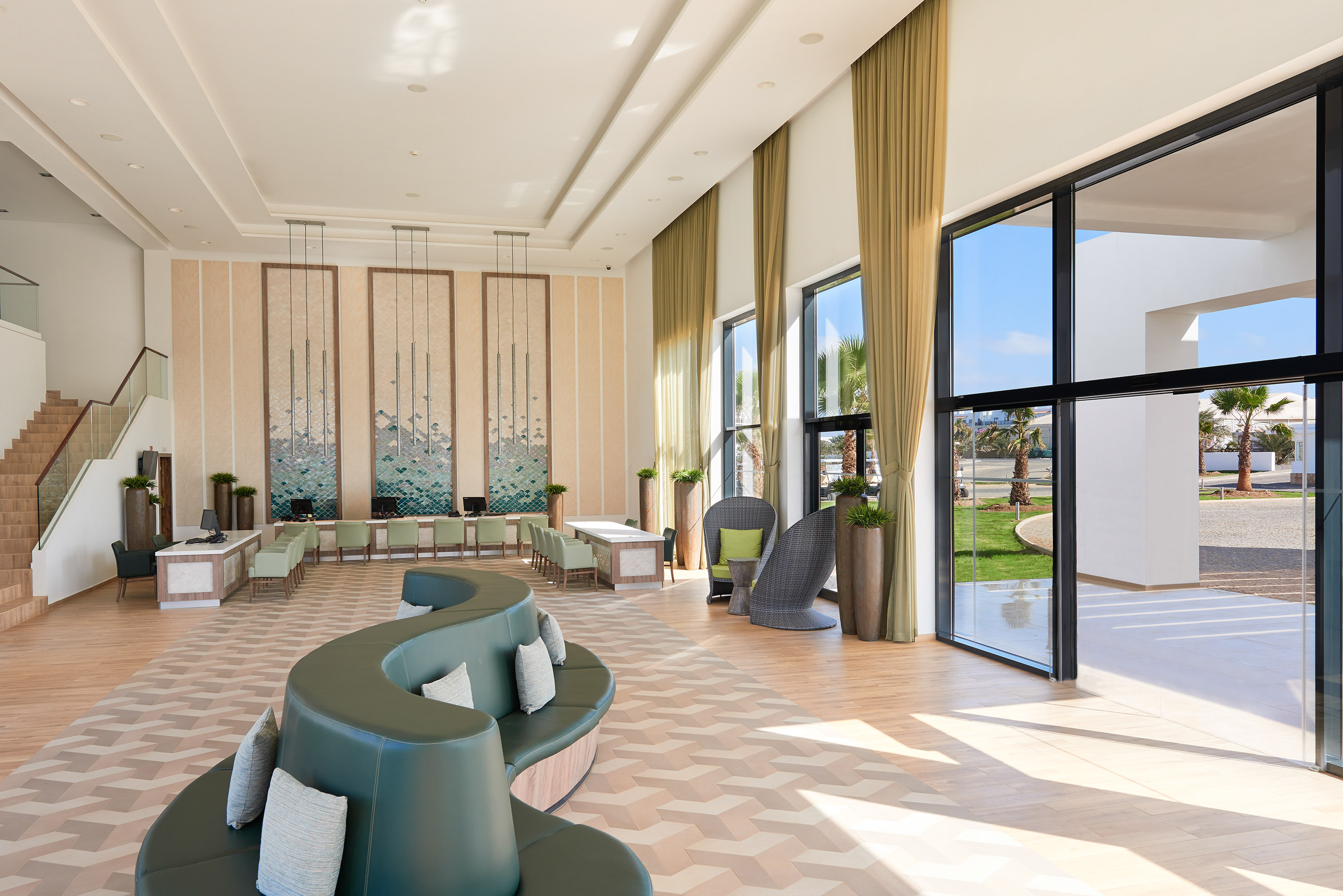 a room with a large couch and chairs