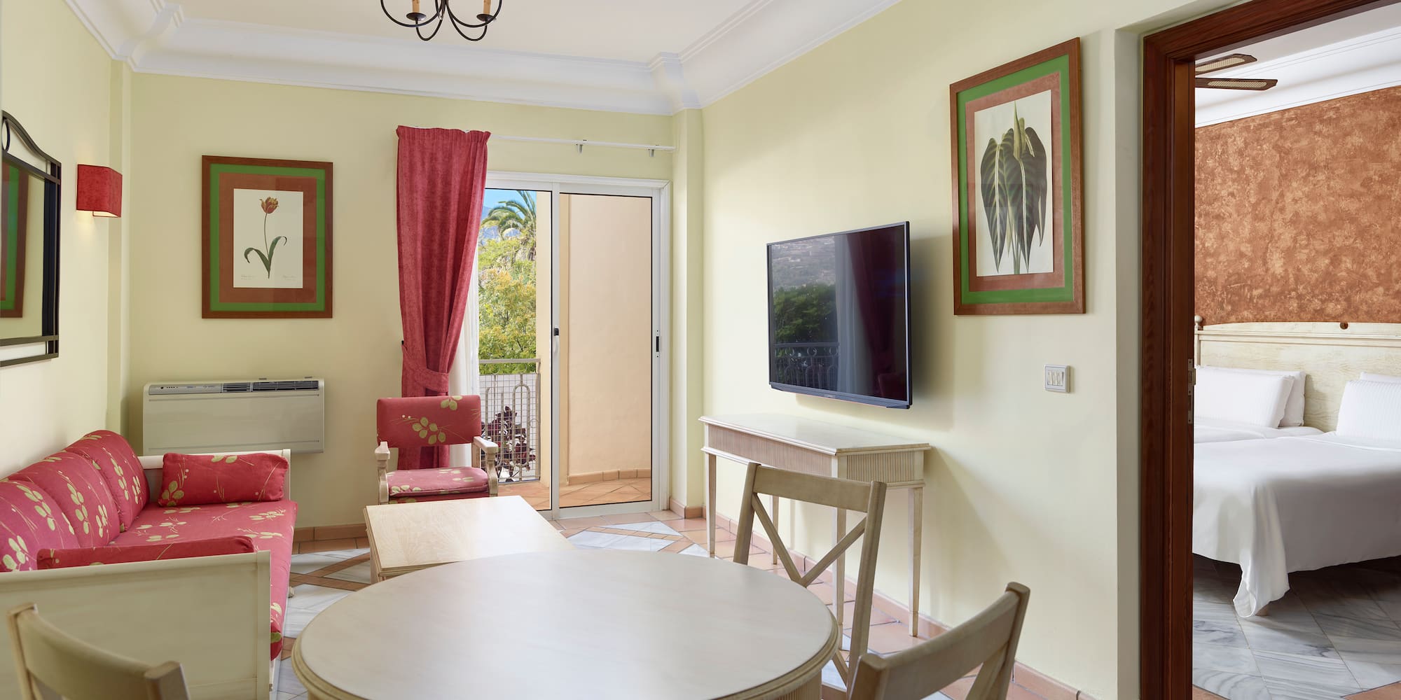 a living room with a table and chairs