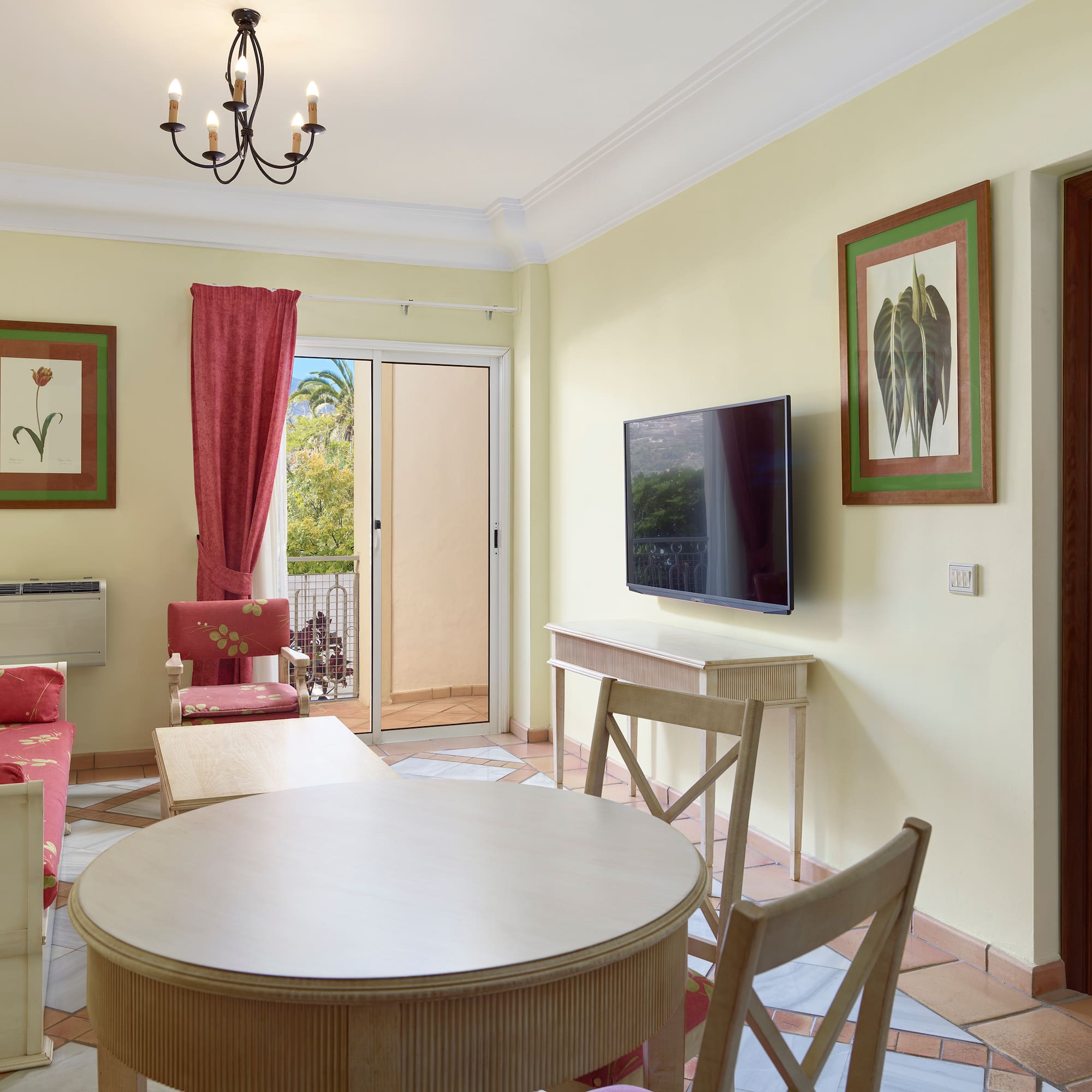 a living room with a table and chairs