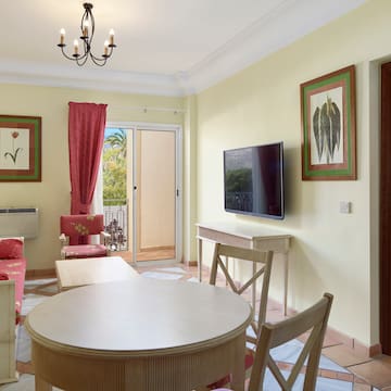 a living room with a table and chairs