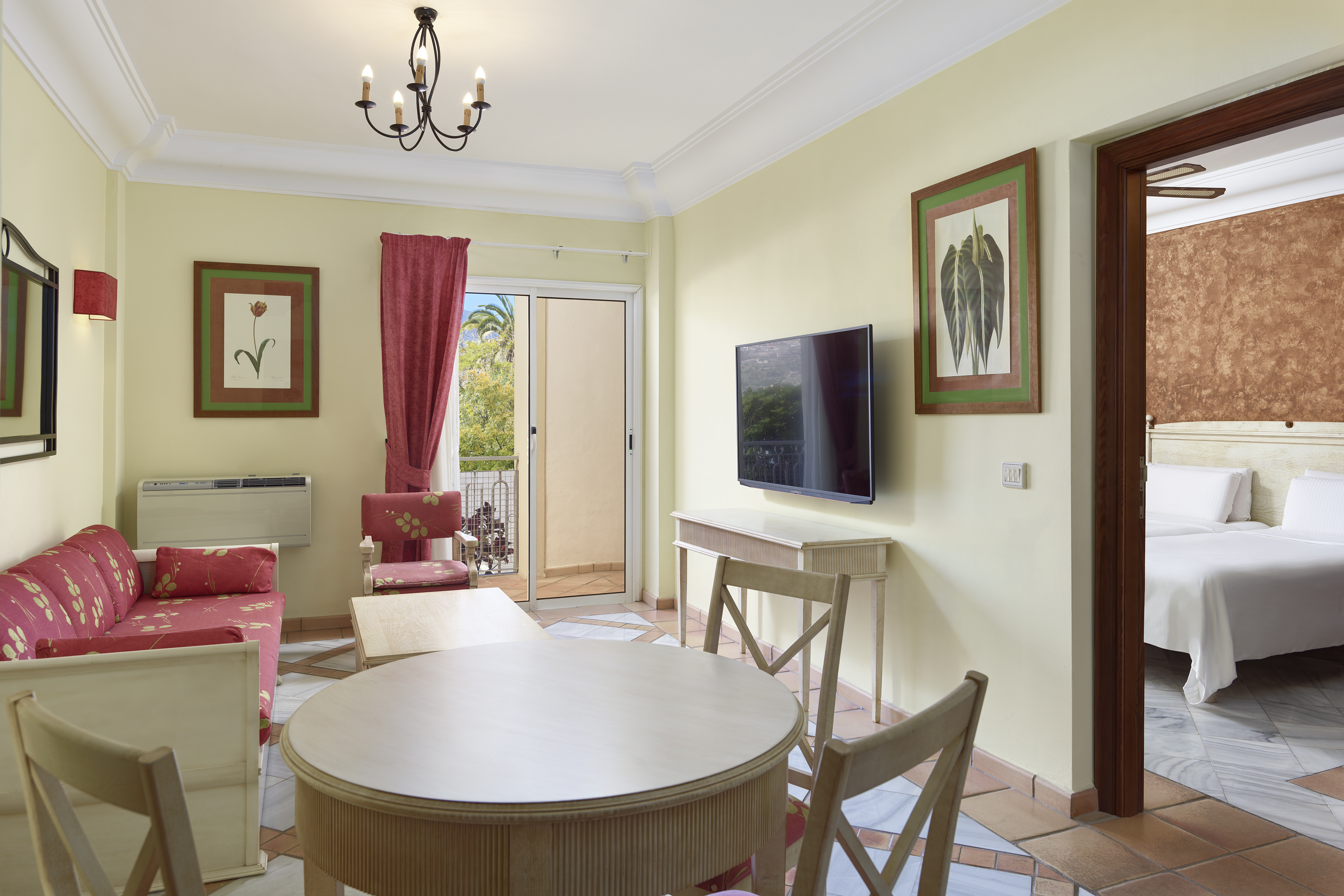 a living room with a table and chairs