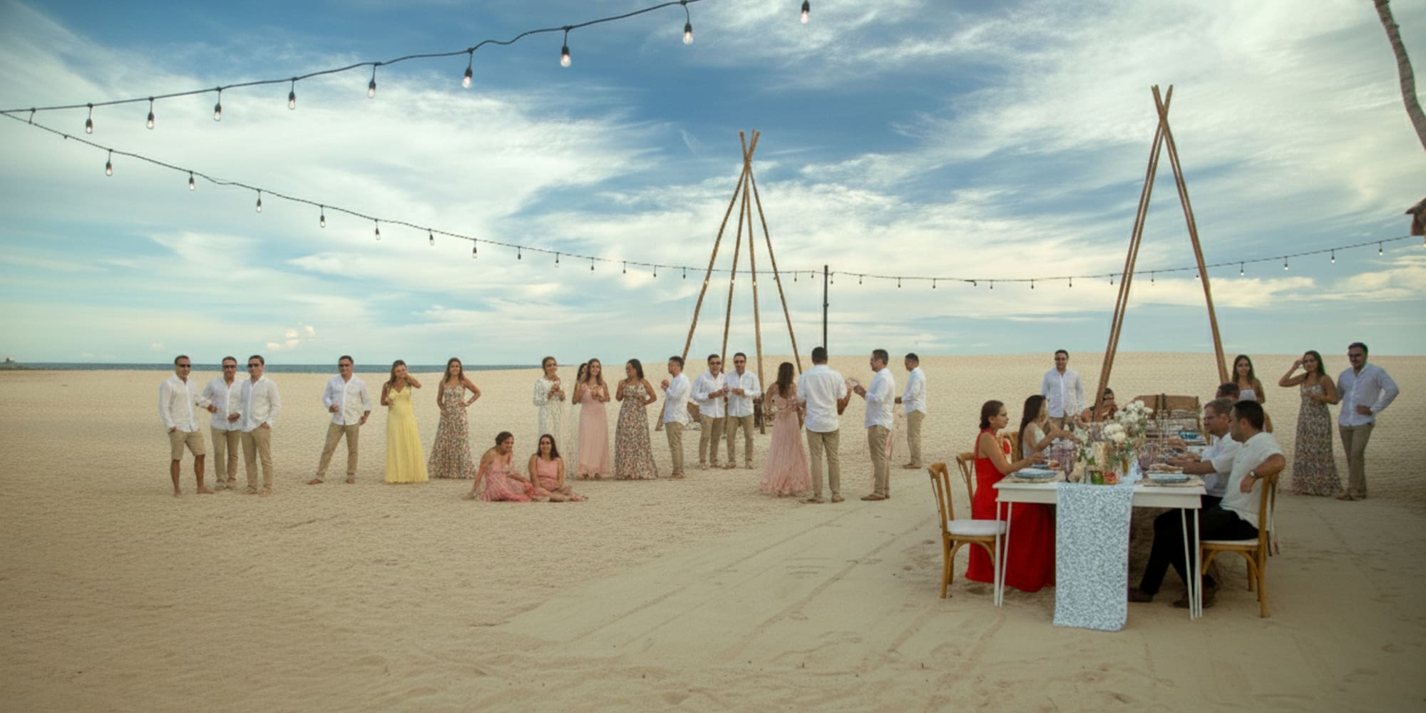 a group of people standing around a table on a beach
