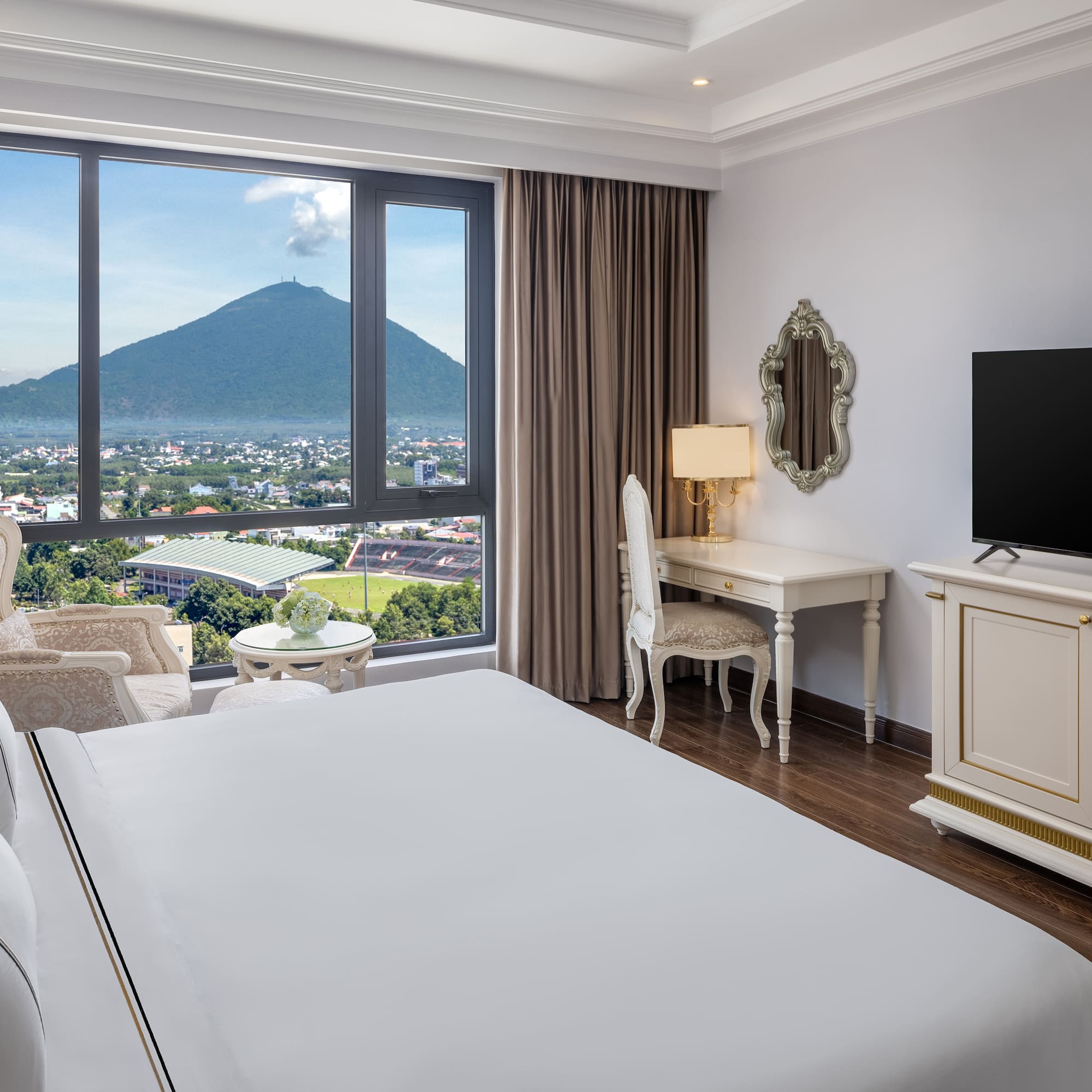 a room with a television and a mountain in the background