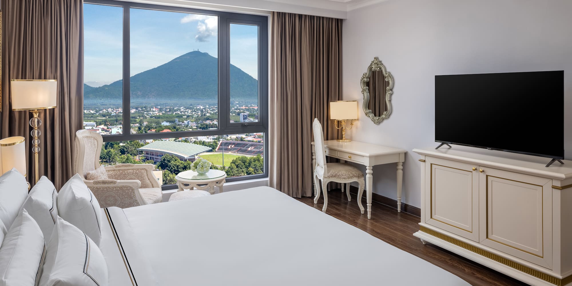 a room with a television and a mountain in the background
