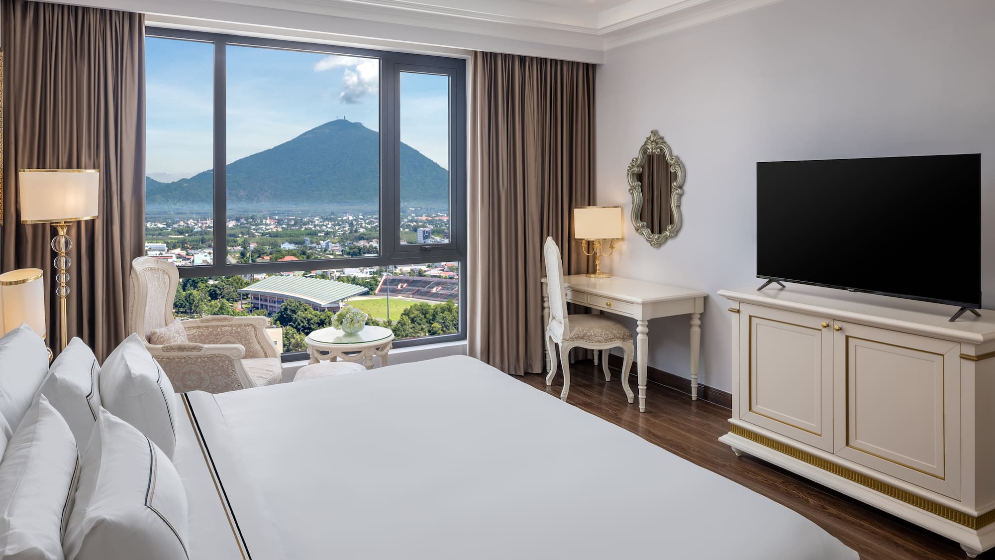 a room with a television and a mountain in the background
