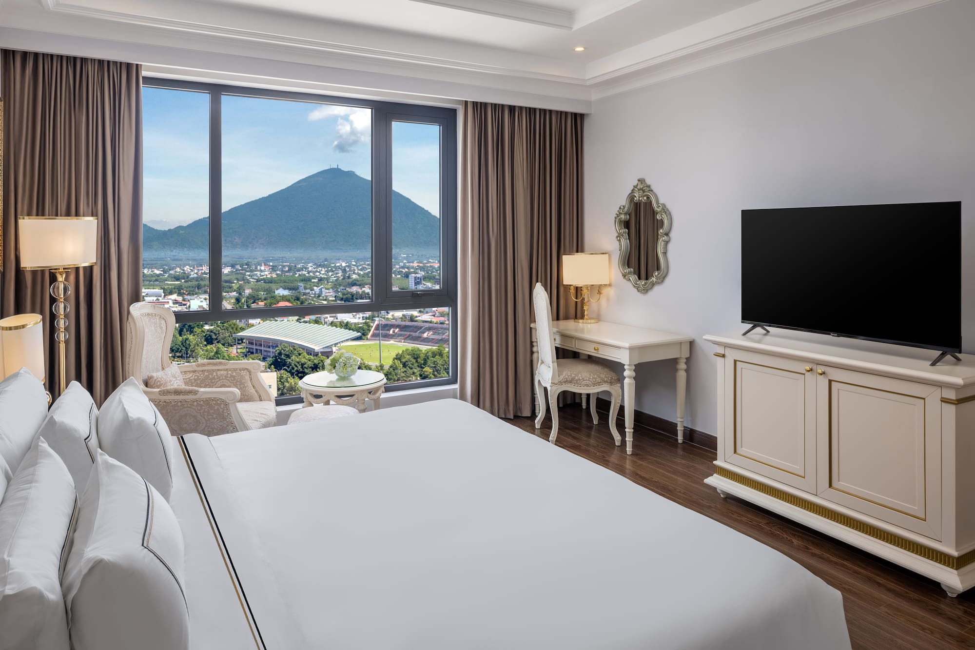 a room with a television and a mountain in the background