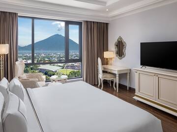 a room with a television and a mountain in the background