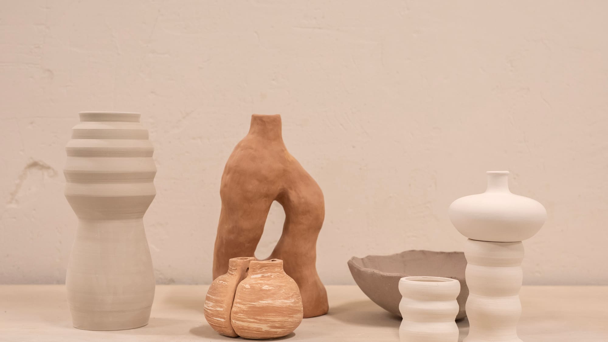 a group of white and brown vases