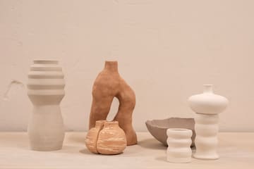 a group of white and brown vases