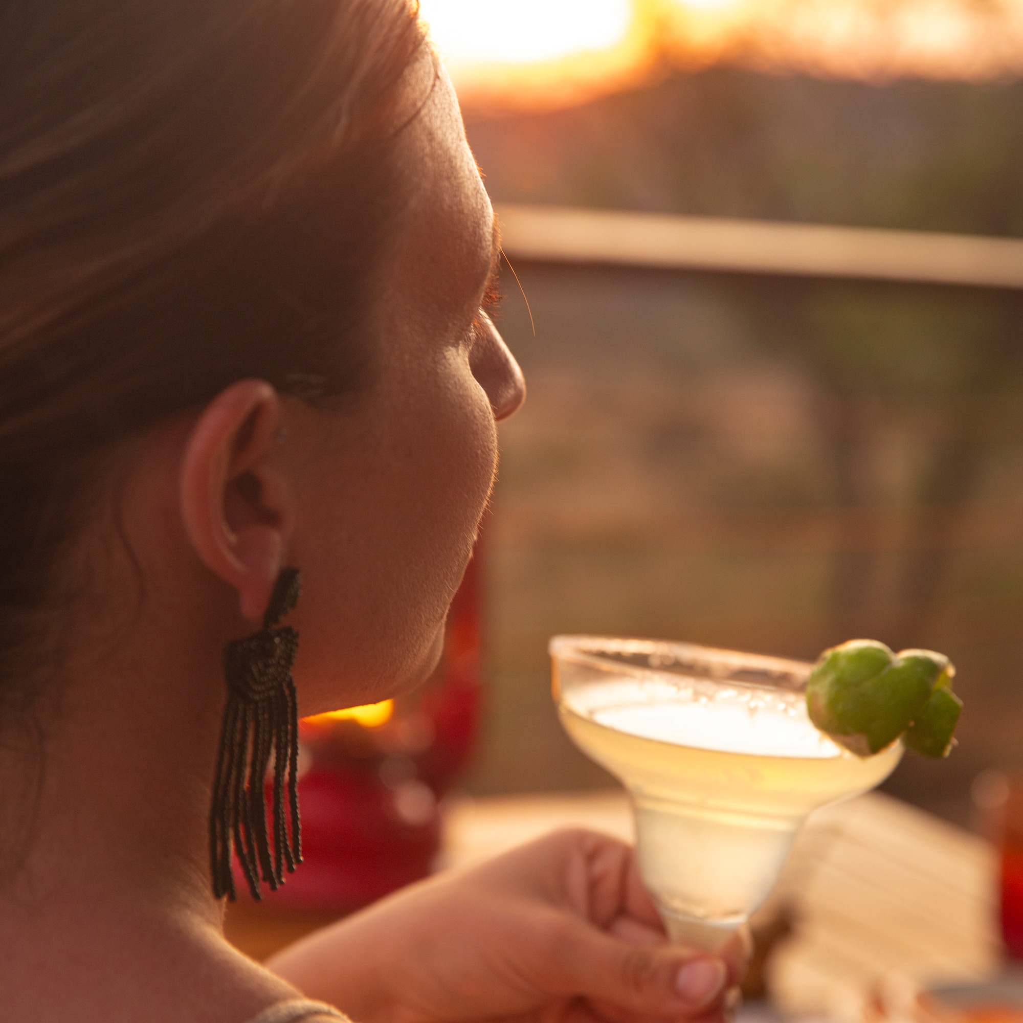 a woman holding a drink
