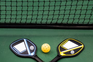 paddles and a ball on a court