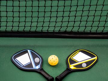 paddles and a ball on a court