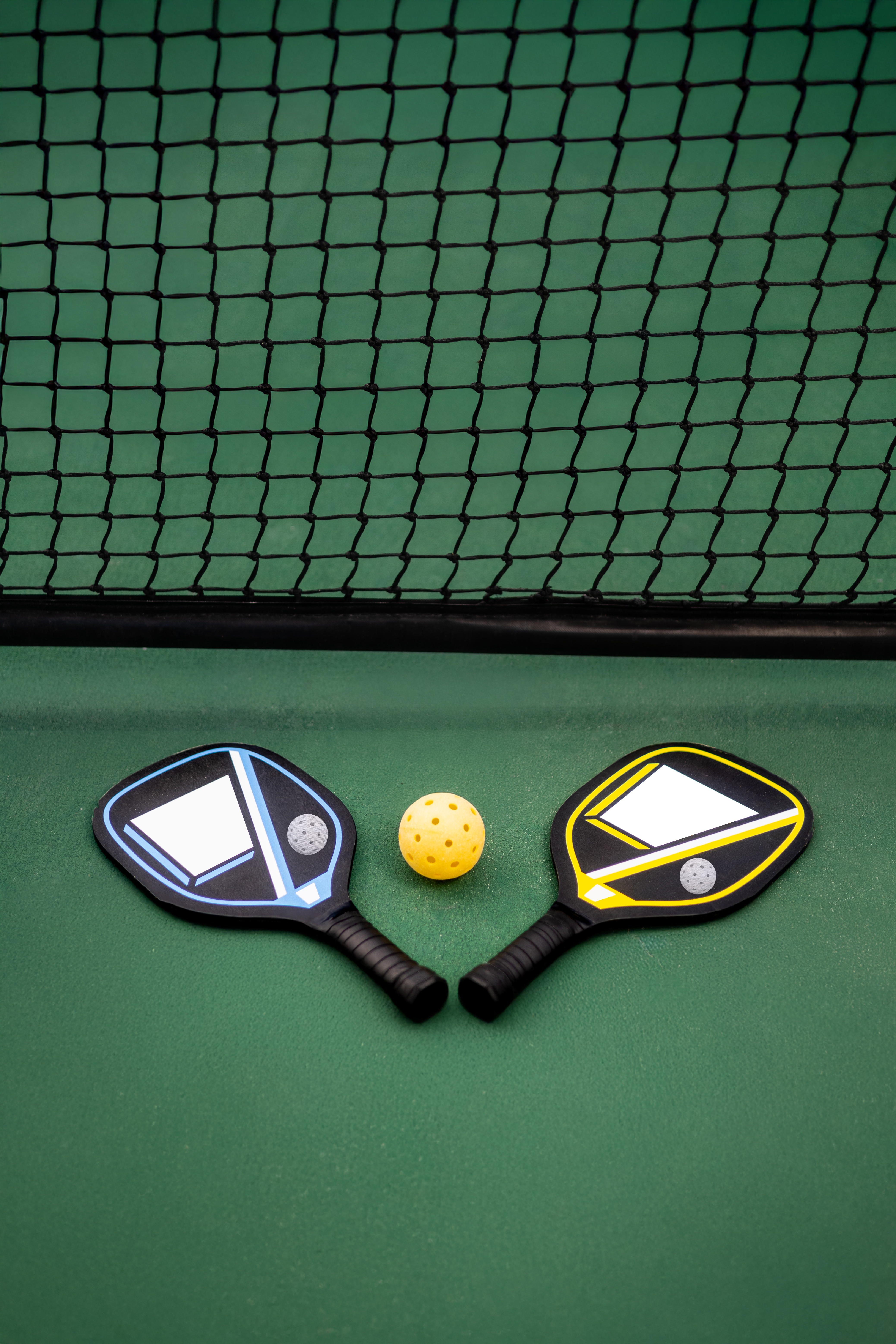 paddles and a ball on a court