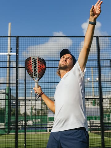 a man holding a tennis racket